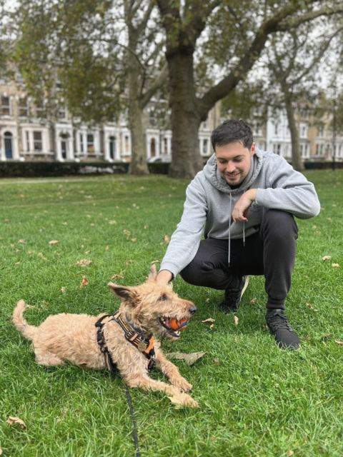 James playing with a dog in a London park — trusted pet sitter London